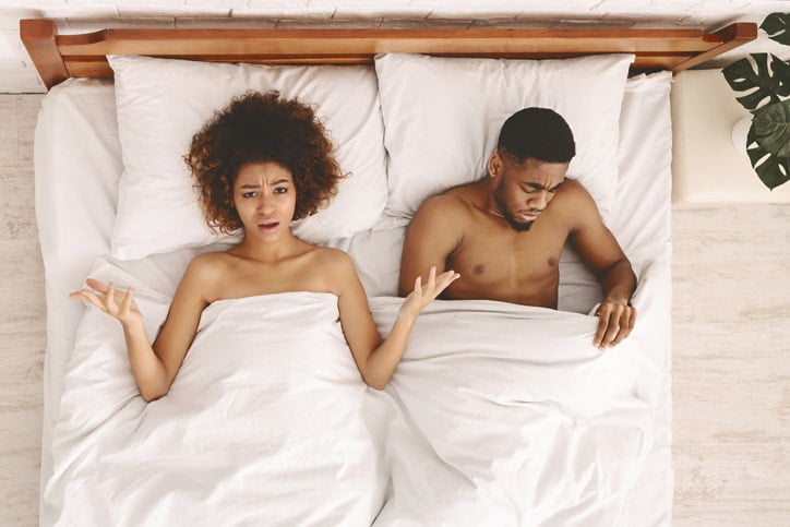 Couple lying in bed, representing the journey to intimacy with simple tricks to cure ED